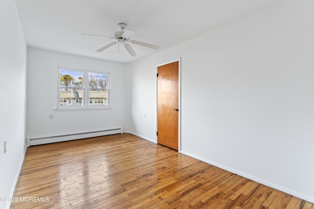 unfurnished room featuring baseboard heating, ceiling fan, and light hardwood / wood-style floors