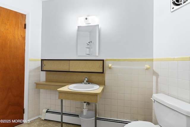 bathroom featuring tile walls, sink, a baseboard radiator, and toilet