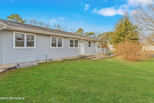 back of house with a lawn