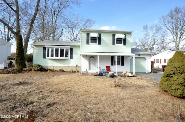 tri-level home with a garage, covered porch, and a front yard