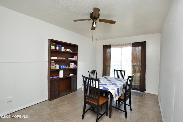 dining area featuring a textured ceiling and ceiling fan