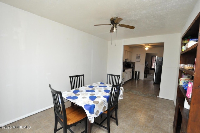 dining space with a textured ceiling