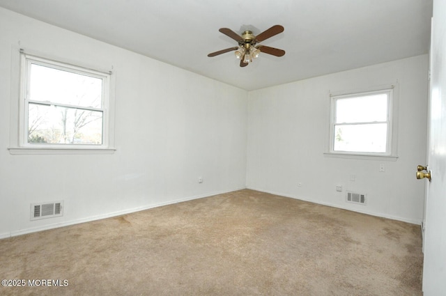 unfurnished room with light carpet, ceiling fan, and a healthy amount of sunlight