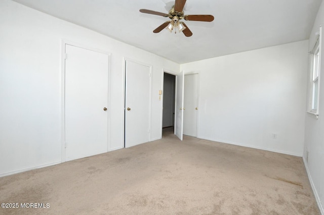 unfurnished bedroom featuring ceiling fan and light colored carpet