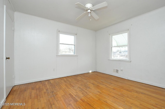 empty room featuring crown molding, light hardwood / wood-style flooring, and ceiling fan