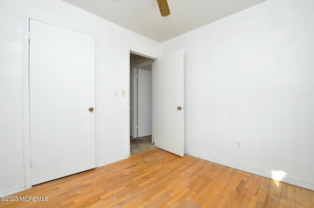 unfurnished bedroom with ceiling fan and light hardwood / wood-style flooring