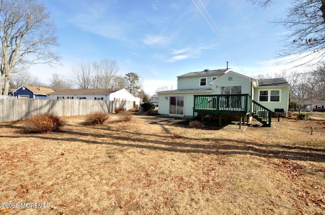 back of property with a yard and a deck