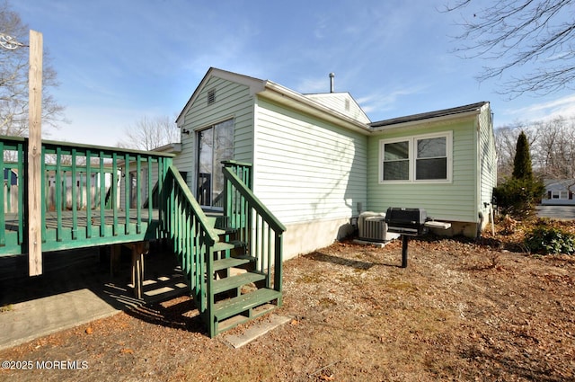 back of property featuring a deck and central AC unit