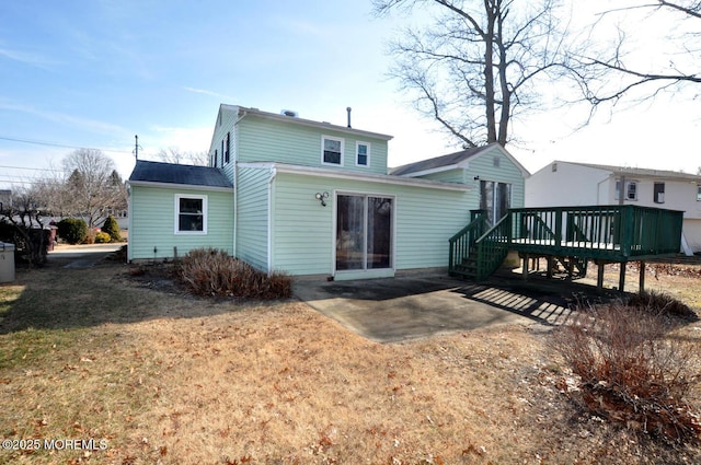 rear view of property with a yard and a deck