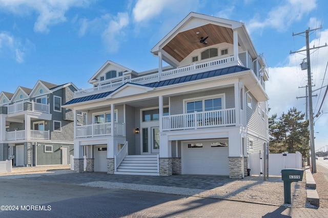 view of front of house featuring a garage and ceiling fan