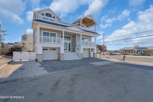 view of front facade featuring a garage and a balcony