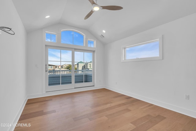 empty room featuring light hardwood / wood-style flooring, ceiling fan, and vaulted ceiling