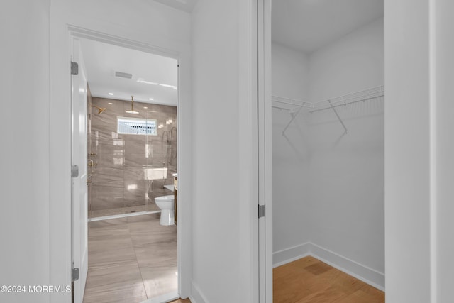 walk in closet featuring light hardwood / wood-style flooring