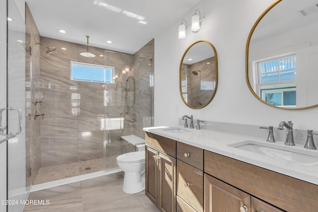 bathroom with vanity, toilet, and a shower with shower door