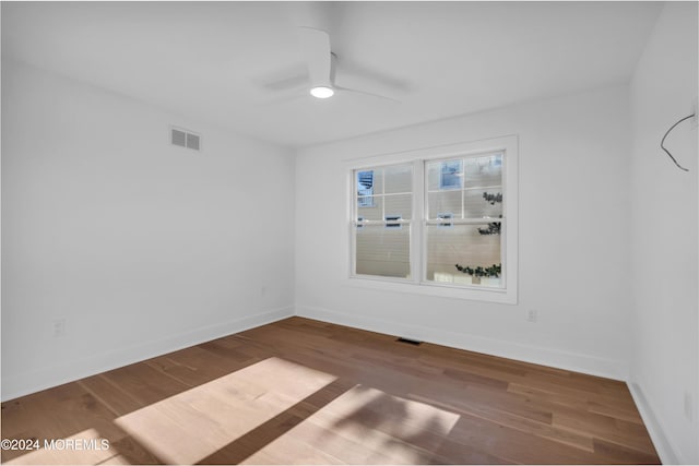 spare room featuring hardwood / wood-style flooring and ceiling fan