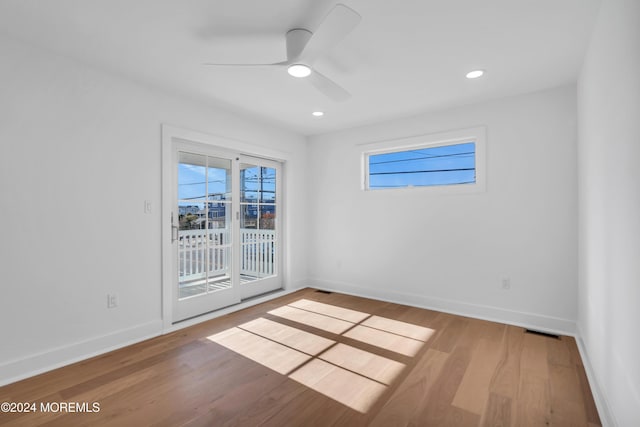 spare room featuring hardwood / wood-style flooring and ceiling fan