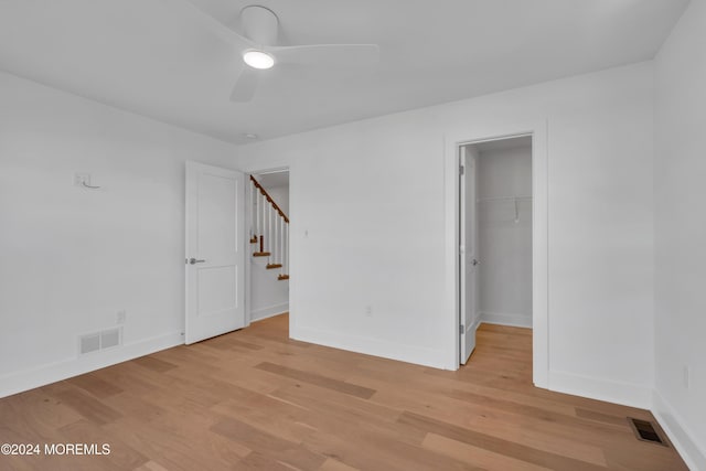 spare room with ceiling fan and light wood-type flooring