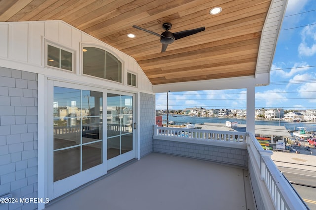 balcony with ceiling fan and a water view