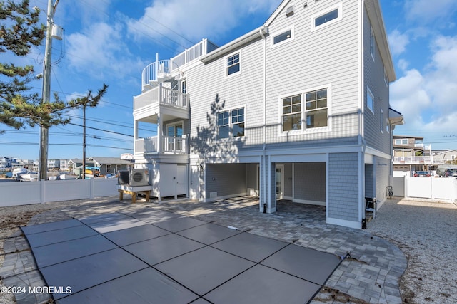 back of house with a balcony and a patio area