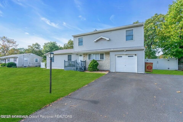 view of front of home featuring a garage and a front lawn