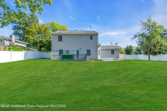 rear view of house featuring a yard