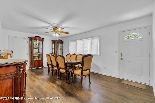 dining room with dark hardwood / wood-style flooring and ceiling fan