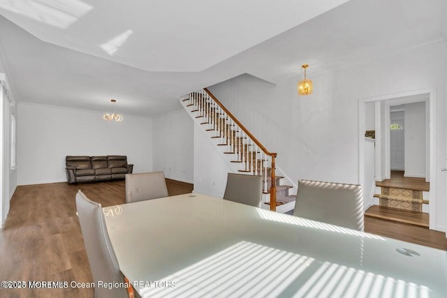 dining area with an inviting chandelier and hardwood / wood-style flooring