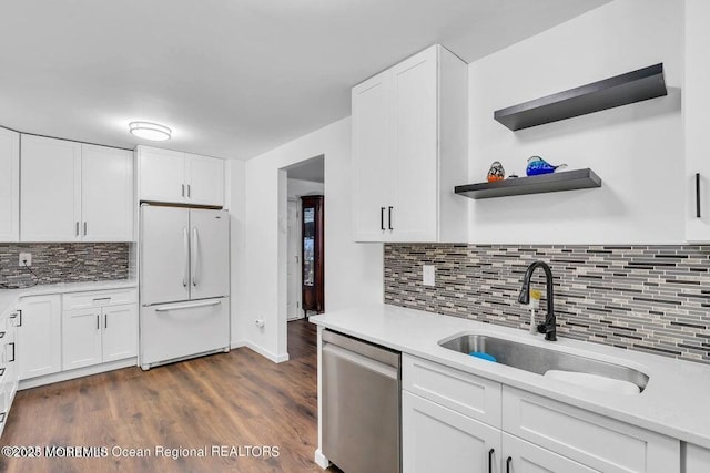 kitchen featuring white cabinetry, dishwasher, and white fridge