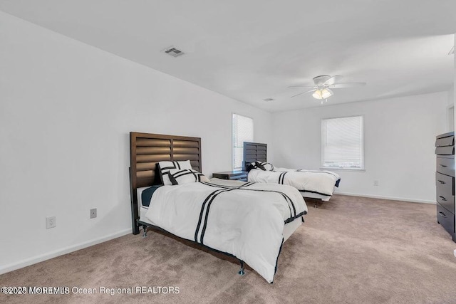 bedroom featuring ceiling fan and light colored carpet