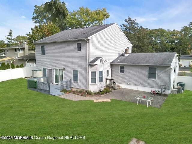 rear view of property featuring central AC, a lawn, and a patio