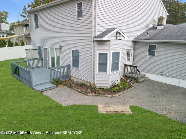 rear view of house featuring a lawn