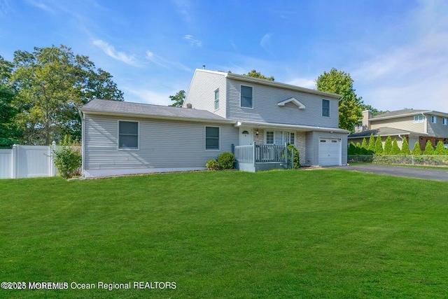 view of front of home with a garage and a front lawn