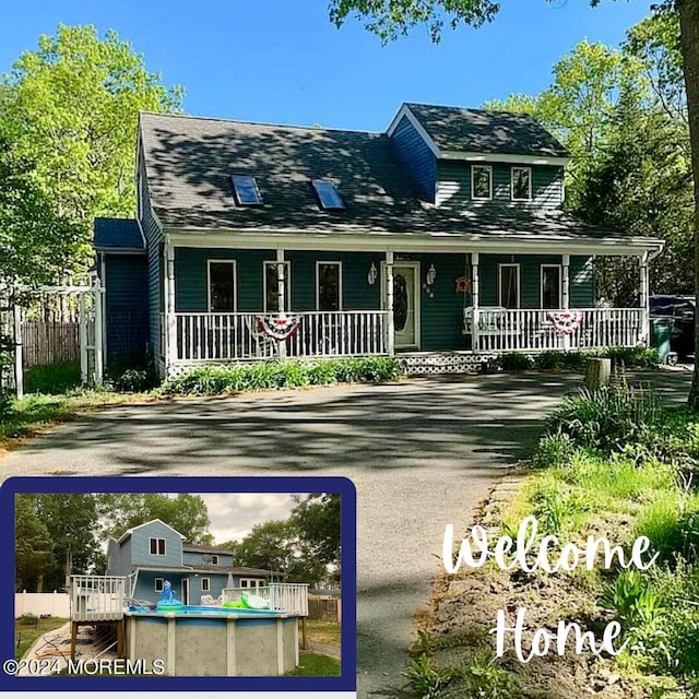 view of front of property featuring covered porch, fence, and an outdoor pool