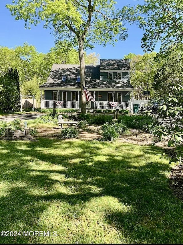 back of house featuring a porch and a yard