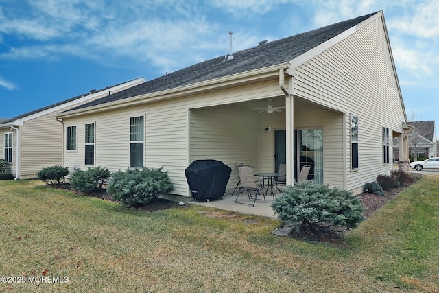 rear view of property with a lawn, ceiling fan, and a patio area