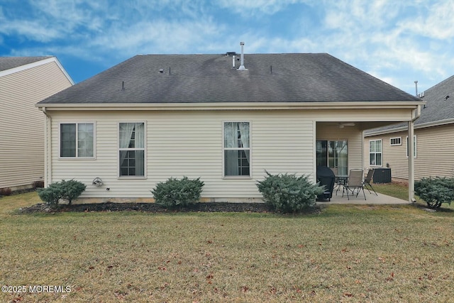 rear view of house with a yard and a patio area