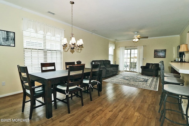 dining room featuring ornamental molding, dark hardwood / wood-style flooring, and ceiling fan with notable chandelier