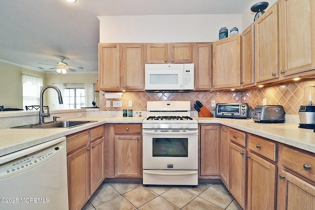 kitchen with tasteful backsplash, sink, ornamental molding, light tile patterned floors, and white appliances