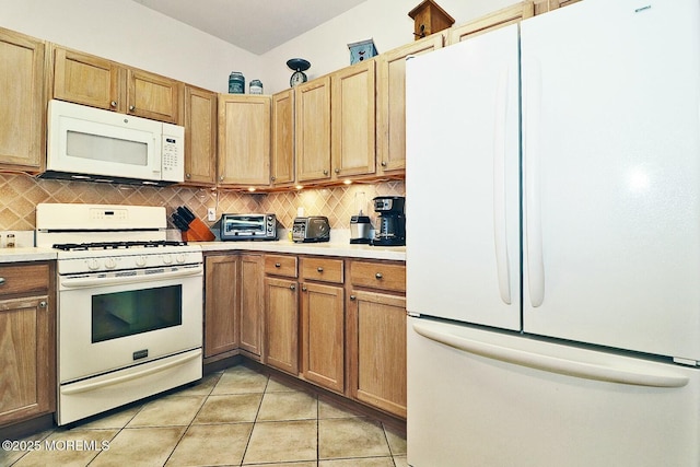 kitchen featuring white appliances, decorative backsplash, and light tile patterned floors