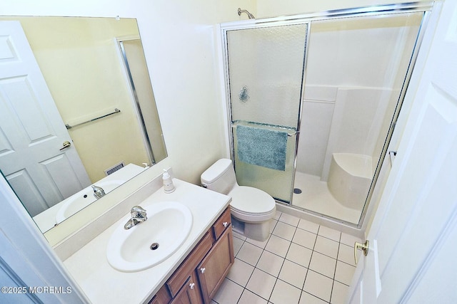 bathroom featuring vanity, an enclosed shower, tile patterned floors, and toilet