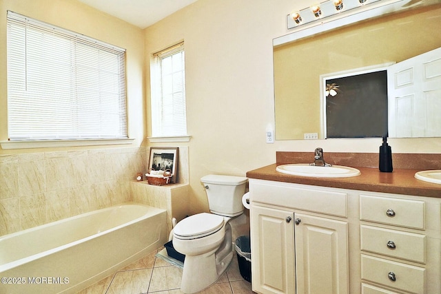 bathroom featuring a tub to relax in, vanity, toilet, and tile patterned flooring