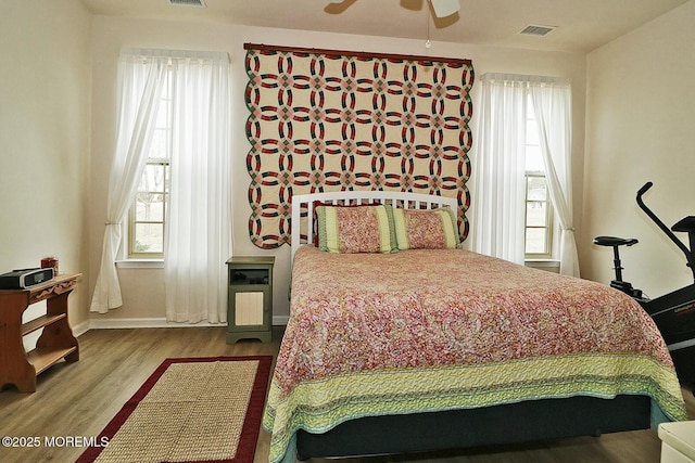 bedroom featuring wood-type flooring and ceiling fan