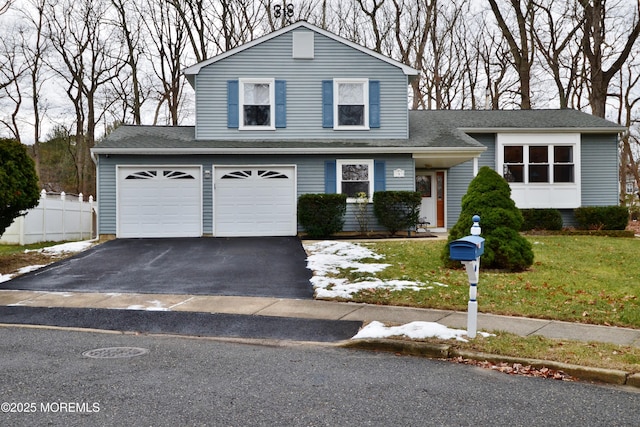 view of front of home with a garage and a front lawn