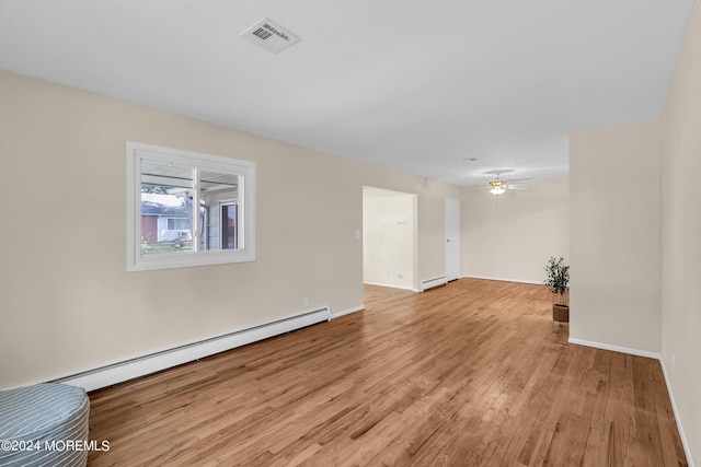 unfurnished room with light wood-type flooring, ceiling fan, and baseboard heating