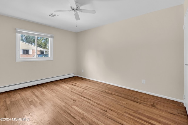 empty room featuring a baseboard radiator, ceiling fan, and light hardwood / wood-style flooring