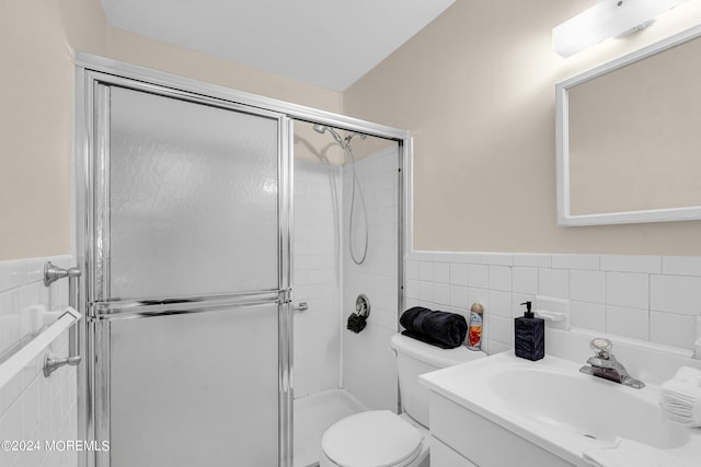 bathroom with vanity, tile walls, an enclosed shower, and toilet