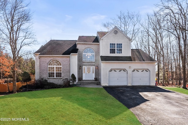 view of property featuring a garage and a front yard