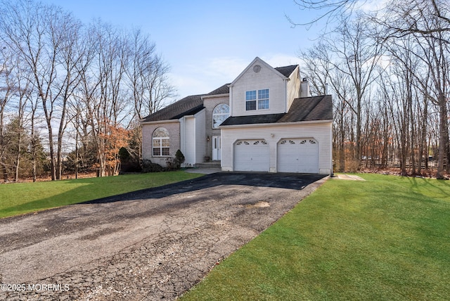 front facade with a garage and a front yard