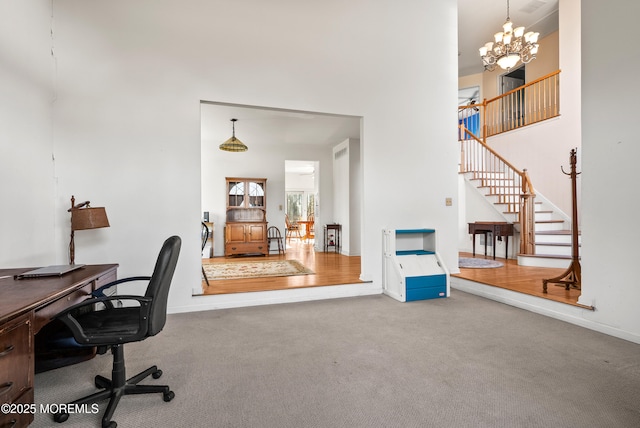 carpeted office featuring a chandelier and a high ceiling