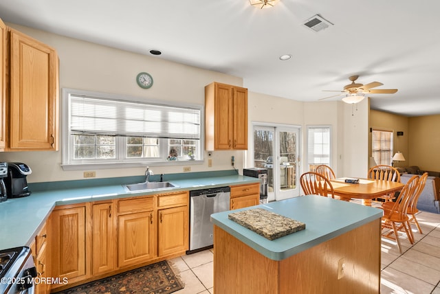 kitchen with light tile patterned flooring, appliances with stainless steel finishes, sink, a center island, and ceiling fan